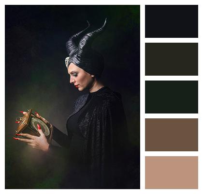 Moody Lighting Dark Attire Costume Intense Gaze Image